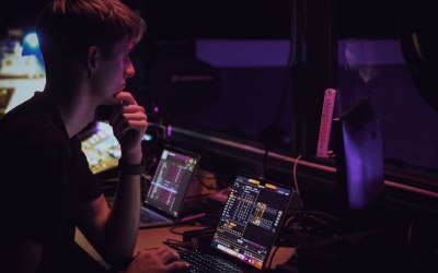 One of our creatives programming lighting for a musical